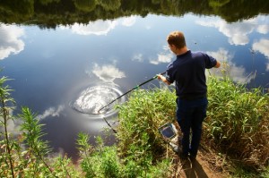 A sampler at the side of a reiver taking a water sample