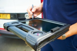 A person completing an in the field sample using a tablet